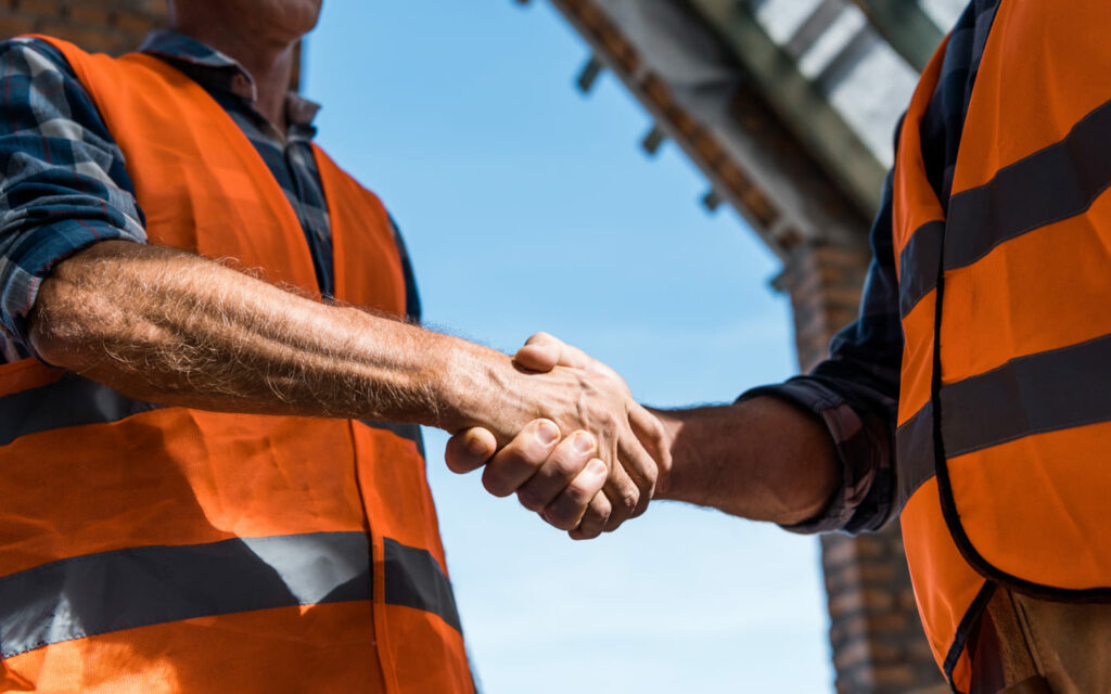 cropped view of men shaking hands against blue sky 2021 09 21 23 41 33 utc 1